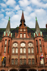 Facade of an old church builded with red brickstones under blie sky 