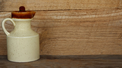 creamer pitcher on wood background