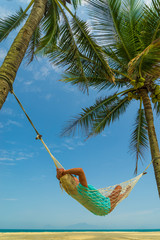 Woman on a hammock at the beach