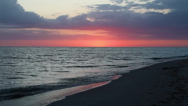 Sanibel Sunset Afterglow Loop - Looping video footage features waves breaking on a sandy beach just after sunset on the Gulf of Mexico at Sanibel Island, Florida.