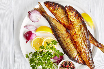 hot smoked herrings on a white plate