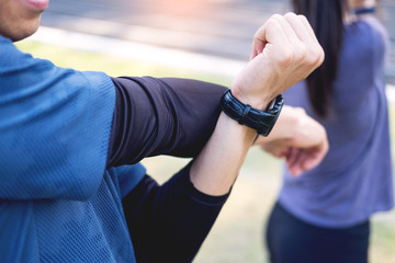 Fototapeta premium Early morning workout, Fitness couple stretching outdoors in park. Young man and woman exercising together in morning, Living healthy lifestyle fitness, sport concept.