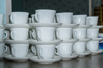 Coffee cups with saucers in stacks
