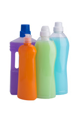 four cleaning bottles with multi-colored liquids on white background