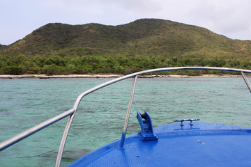 first person view of blue steel moving boat with Seascape and Clear Sky , perspective exploring the ocean, traditional long tail boat, commercial advertisement