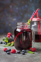 Berry drink with fresh blueberries and raspberries, berry ice lemonade in a glass