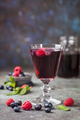 Berry drink with fresh blueberries and raspberries, berry ice lemonade in a glass