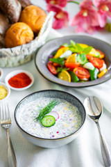 Traditional Russian summer cold soup. Russian breakfast. okroshka with salad and bread