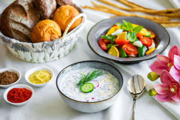 Traditional Russian summer cold soup. Russian breakfast. okroshka with salad and bread