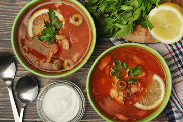 Two bowls with traditional Russian soup solyanka