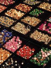 Close-up of Indian woman jewelry beads and stones in display for sale