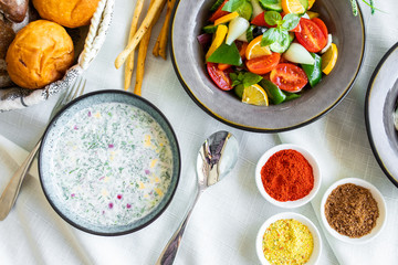Traditional Russian summer cold soup. Russian breakfast. okroshka with salad and bread