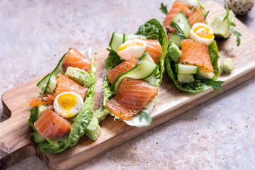Lettuce wrapped smoked salmon tacos with fresh cucumber, avocado and quail eggs