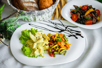 Steamed, cooked vegetables. mushrooms stewed in white sauce with vegetables, carrots,   green beans, pepper, tomato. Vegan lunch, vegetarian dinner, healthy food