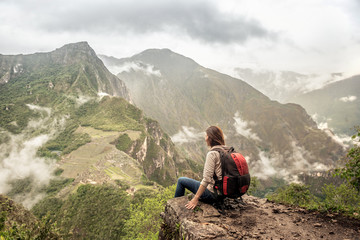 Fototapeta premium Girl-hiker looking on top of Huayna Picchu, looking on Machu Picchu