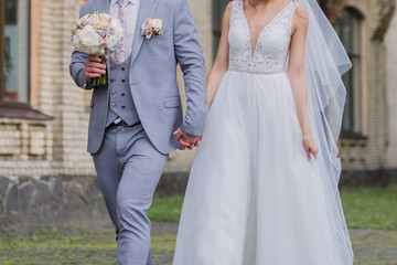 bride and groom walk down the street together