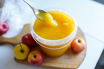 honey with red apples on wooden board on light bakground . healthy tasty food