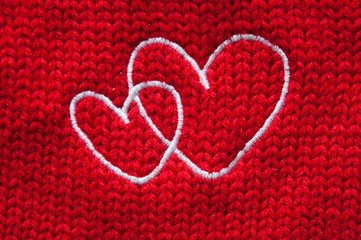 white hearts embroidered handmade with a cross on a red canvas