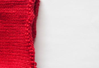 Red Knitted pattern wool sweater texture close up. Handmade red knitting wool texture background