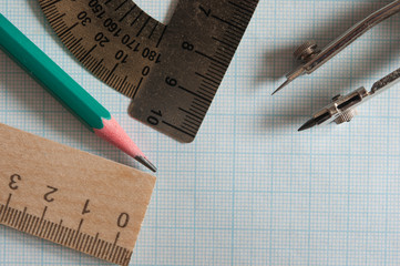 Set of drawing instrument and rulers on graph paper