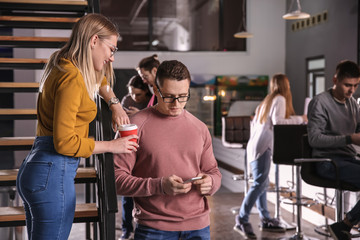 Young colleagues during coffee break in cafe