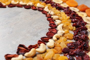 Assortment of tasty dried fruits on grey background