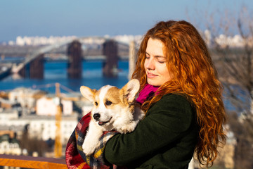 young woman with welsh corgi puppy