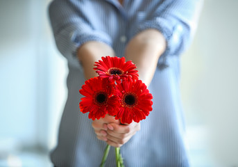 Young woman with bouquet of beautiful flowers, closeup