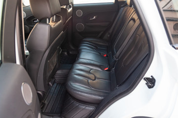 View to the interior of car with opened rear door and seats after cleaning before sale on parking