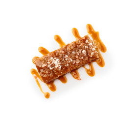 Tasty salty caramel candy on white background