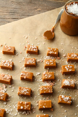 Tasty salty caramel candies on parchment