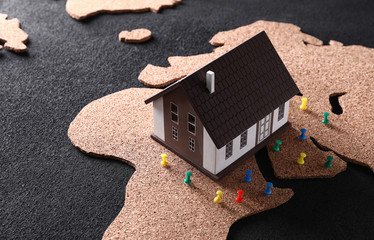 Model of house with pins on map. Concept of earthquake