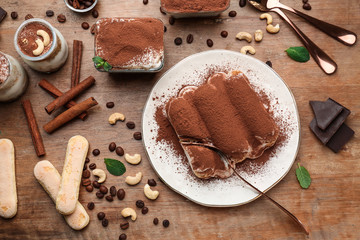 Plate with tasty tiramisu on wooden table