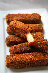 Plate with tasty mozzarella sticks, closeup