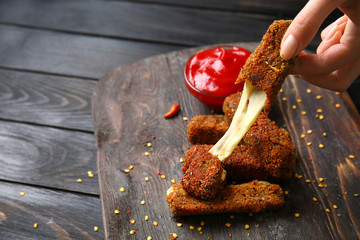 Woman eating tasty mozzarella sticks