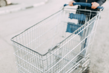 Food basket and the girl's hands. Trolley for shopping products in the supermarket.