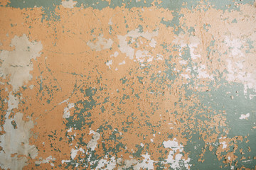Textured wall of the old house. The texture of old cracked concrete with paint.