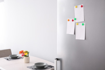 Papers with magnets on fridge door
