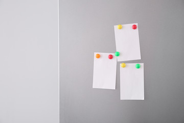 Papers with magnets on fridge door