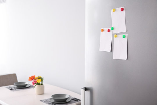 Papers With Magnets On Fridge Door