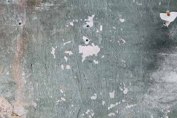 Textured wall of the old house. The texture of old cracked concrete with paint.