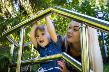 Obraz premium Cute blonde woman and her daughter have fun in the park