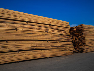 Set of wooden products in a warehouse or sawmill. A warehouse of timber for sale or construction