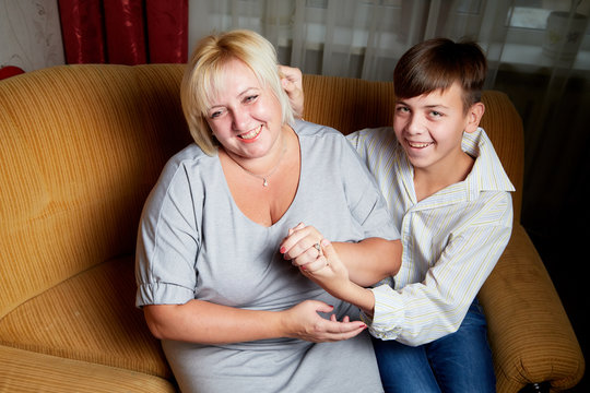 Adalt mother and her young son at home
