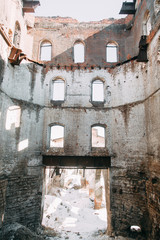 Destroyed historical building as in the war. Old abandoned factory outside.
