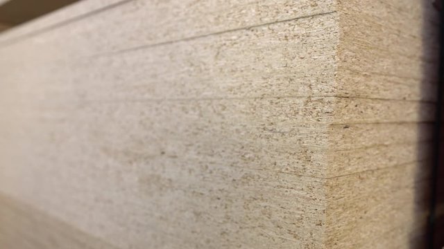 Big stack of full size OSB chipboard on pallet.