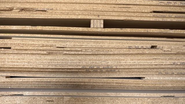 Big stack of full format chipboard sorted by thickness on pallet