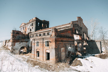 Destroyed historical building as in the war. Old abandoned factory outside.