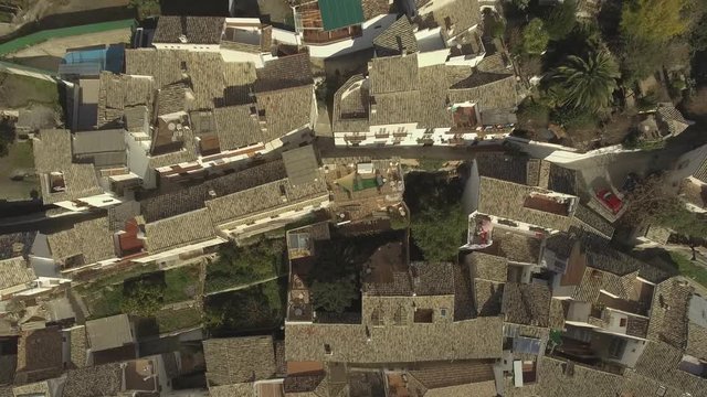 Aerial shot of sightly stacked white buildings in Cazorla city located at the foot of the mountain in Sierra de Cazorla