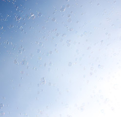 Soap bubbles fly in the blue sky